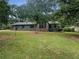 House exterior showcasing a ranch style home with a large yard at 3551 Mill Glen Dr, Douglasville, GA 30135