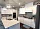 Modern kitchen with white cabinets, granite countertops, and stainless steel appliances at 310 Ellington Dr, Canton, GA 30115