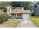 Two-story house with tan siding, white trim, and a small porch at 3274 Forette Ln, Lithonia, GA 30038