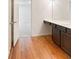 Bathroom with dark brown vanity and wood-look flooring at 7482 Saint David St, Fairburn, GA 30213