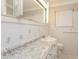 Bathroom with granite countertop, floral tile, and a large mirror at 2072 Clairmont Ter, Atlanta, GA 30345