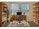 Bright home office with built-in shelving and large windows at 5791 Peltier Trce, Norcross, GA 30093