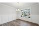 Bright dining room features hardwood floors, wainscoting, and a chandelier at 1522 Dover Creek Ln, Lawrenceville, GA 30045