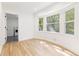 Light-filled bedroom with hardwood floors and laundry access at 1972 Peeler Rd, Atlanta, GA 30338