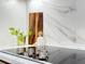 Close-up of a sleek electric cooktop with marble backsplash at 1972 Peeler Rd, Atlanta, GA 30338