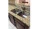 Kitchen features a double stainless steel sink with granite countertop at 2700 Pine Tree Ne Rd # 1005, Atlanta, GA 30324