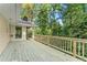 Large deck overlooking wooded backyard at 5775 Lakeshore Dr, Buford, GA 30518