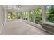 Sunroom with wall-to-wall windows and carpeted floors at 5775 Lakeshore Dr, Buford, GA 30518