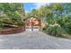 Brick house exterior with two-car garage and stairs at 5775 Lakeshore Dr, Buford, GA 30518