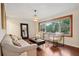 Bright living room features hardwood floors, comfy seating, and a large window overlooking the backyard at 822 Gertrude Nw Pl, Atlanta, GA 30318