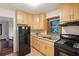 Kitchen with light wood cabinets, gas range, and stainless steel sink at 822 Gertrude Nw Pl, Atlanta, GA 30318