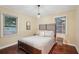 Cozy bedroom with full-size bed, hardwood floors, and window at 822 Gertrude Nw Pl, Atlanta, GA 30318