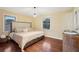 Main bedroom with king-size bed, hardwood floors, and ample natural light at 822 Gertrude Nw Pl, Atlanta, GA 30318