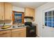 Kitchen with light wood cabinets, gas range, and window at 822 Gertrude Nw Pl, Atlanta, GA 30318