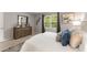 Main bedroom with dresser, bed, and neutral color scheme at 46 Monet Nw Ct, Atlanta, GA 30327