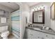 Updated bathroom with granite countertop, white cabinets, and striped shower curtain at 46 Monet Nw Ct, Atlanta, GA 30327