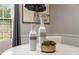 Close-up view of marble table centerpiece with vases and succulents at 46 Monet Nw Ct, Atlanta, GA 30327