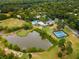 Aerial view of community with pool, tennis courts, and pond at 46 Monet Nw Ct, Atlanta, GA 30327