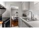 Modern kitchen with white cabinets, stainless steel appliances, and subway tile backsplash at 46 Monet Nw Ct, Atlanta, GA 30327