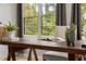 Rustic wooden desk in a home office, with natural light streaming through windows at 46 Monet Nw Ct, Atlanta, GA 30327