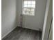 Small laundry room with wood-look flooring and beadboard walls at 64 Luther Knight Se Rd, Cartersville, GA 30121