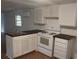 Cozy kitchen featuring white cabinets, wood countertops, and modern appliances at 64 Luther Knight Se Rd, Cartersville, GA 30121