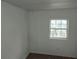 Simple bedroom with wood flooring and beadboard walls at 64 Luther Knight Se Rd, Cartersville, GA 30121