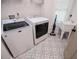 Modern laundry room with patterned floor and utility sink at 1483 Pleasant Grove Church Rd, Villa Rica, GA 30180