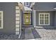 Front entry with yellow door, stone pathway, and gray exterior at 103 Royal Way, Mcdonough, GA 30252