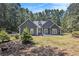 Gray house exterior with yellow door, landscaping, and driveway at 103 Royal Way, Mcdonough, GA 30252