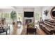 Spacious living room with hardwood floors, fireplace, and large TV at 103 Royal Way, Mcdonough, GA 30252