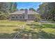 Gray house back with stone walkway, patio, and fenced yard at 103 Royal Way, Mcdonough, GA 30252