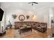 Open living room with hardwood floors, sectional sofa, and large windows at 103 Royal Way, Mcdonough, GA 30252