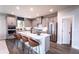 Modern kitchen with gray cabinets, white quartz island, and stainless steel appliances at 7635 Homer Dr, Cumming, GA 30028