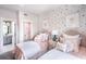 Charming bedroom with twin beds and colorful wall decor at 7635 Homer Dr, Cumming, GA 30028