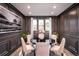 Formal dining room with dark wood walls and round table at 7635 Homer Dr, Cumming, GA 30028