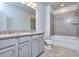 Bathroom with double vanity, granite countertop, and shower/tub combo at 6186 Ripple Way # 84, South Fulton, GA 30349