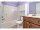 Full bathroom with shower, toilet, and wood vanity at 3928 Herron Sw Ln, Atlanta, GA 30349