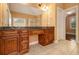 Double vanity bathroom with wood cabinets and tile floors at 3928 Herron Sw Ln, Atlanta, GA 30349