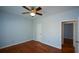Bedroom with hardwood floors, ceiling fan, and access to another room at 6865 Cowan Mill Rd, Winston, GA 30187