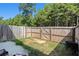 Fenced backyard with a patio and access gate at 3511 Lakeview Crk, Lithonia, GA 30038