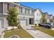Townhome exterior featuring two-story design, attached garage, and landscaping at 3511 Lakeview Crk, Lithonia, GA 30038