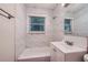 Updated bathroom with marble tile, bathtub, and vanity at 700 Symphony Nw Ln, Atlanta, GA 30318