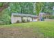 Brick ranch house with green lawn and trees at 700 Symphony Nw Ln, Atlanta, GA 30318