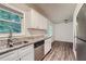 White kitchen cabinets and granite countertops with stainless steel appliances at 700 Symphony Nw Ln, Atlanta, GA 30318