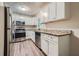 Modern kitchen with white cabinets, granite counters, and stainless steel appliances at 700 Symphony Nw Ln, Atlanta, GA 30318