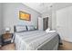 Bedroom with gray bedding, nightstand, and large window at 10 Argyll Way, Covington, GA 30014