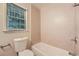 Simple bathroom with a shower/tub combo and neutral tile at 1123 Redan Way, Stone Mountain, GA 30088