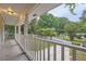 Covered porch overlooks tree-lined street and driveway at 1123 Redan Way, Stone Mountain, GA 30088