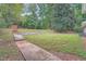 Landscaped backyard with large grassy area and walkway at 1123 Redan Way, Stone Mountain, GA 30088